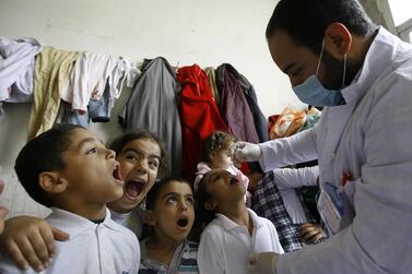 Syrian refugee children line up to receive vaccinations against polio at a camp in Lebanon. Mohammed Zaatari / AP