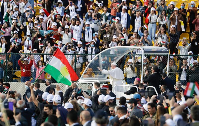 Pope Francis arrives on the popemobile to celebrate Mass at the Franso Hariri Stadium in Erbil. AP Photo