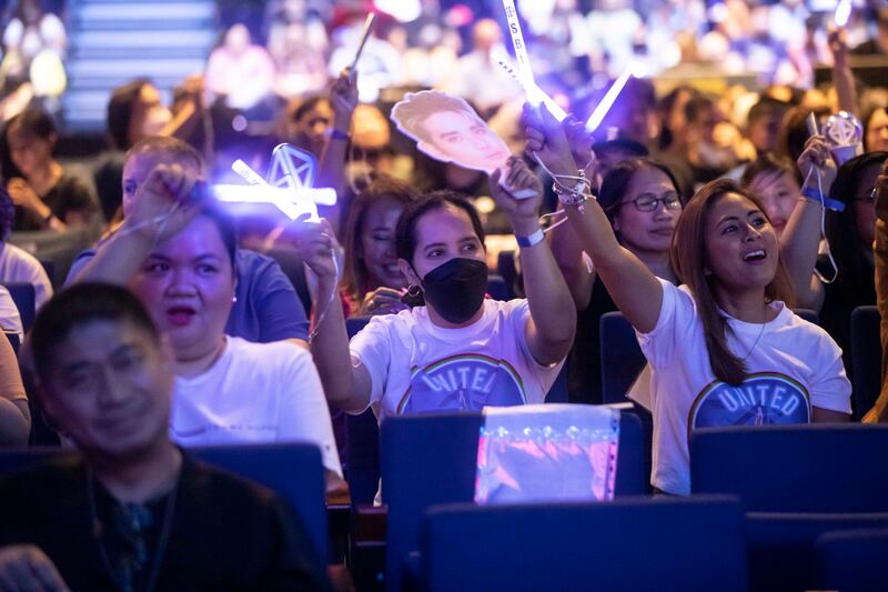 Fans with signs at their concert at Dubai World Trade Centre.