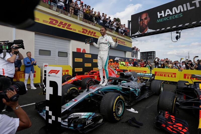 Mercedes driver Lewis Hamilton of Britain celebrates while standing on his car after winning the French Formula One Grand Prix at the Paul Ricard racetrack, in Le Castellet, southern France, Sunday, June 24, 2018. (AP Photo/Claude Paris)