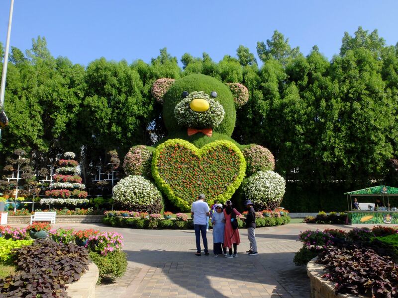 A teddy bear made from flowers, grass and moss. 