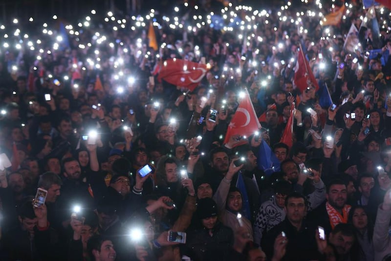 Supporters of Turkey's ruling AKP cheer as they follow the election's results in front of the party's headquarters in Ankara on March 30. Adem Altan/ AFP Photo

