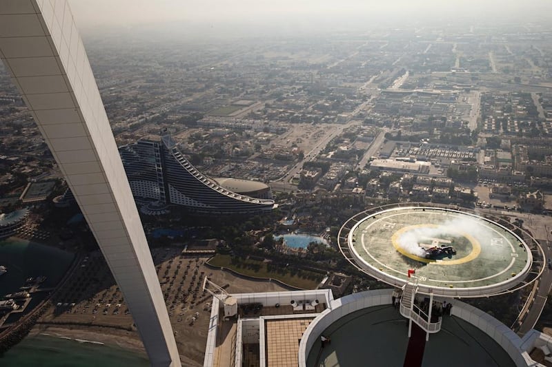 David Coulthard of Scotland performs in a Red Bull Racing Formula One car on the helipad of the Burj Al Arab hotel in Dubai, United Arab Emirates on October 30, 2013. // Samo Vidic/Red Bull Content Pool 