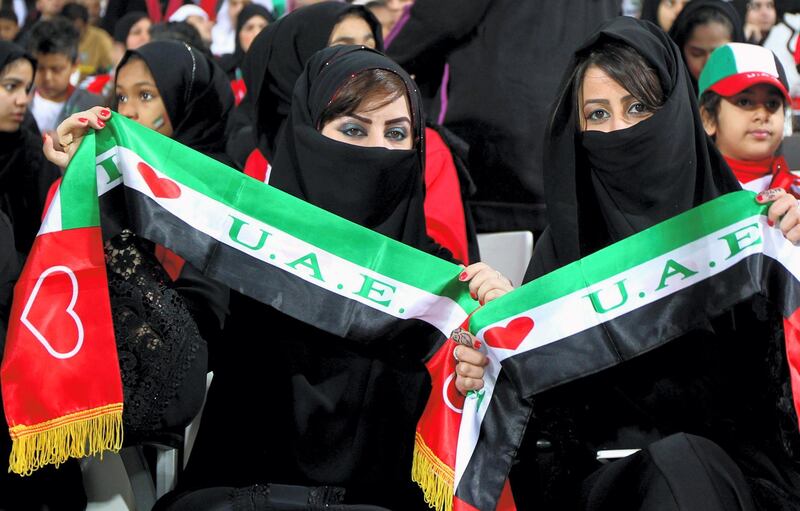Supporters of the United Arab Emirates (UAE) wave scarfs prior the start of the Gulf Cup's final football match between UAE and Iraq on January 18, 2013 in Manama . AFP PHOTO/MARWAN NAAMANI
 *** Local Caption ***  289371-01-08.jpg