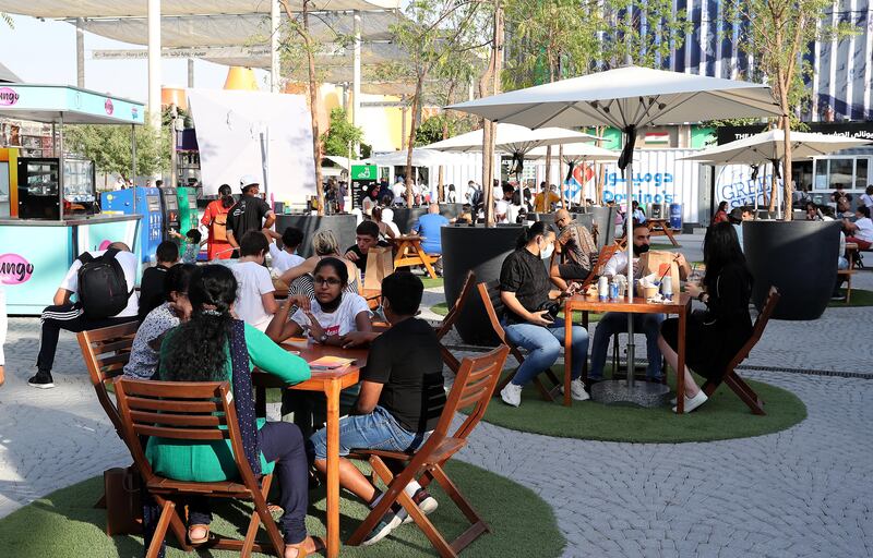 Visitors tuck in at the food trucks at the Expo 2020 Dubai site. Pawan Singh / The National