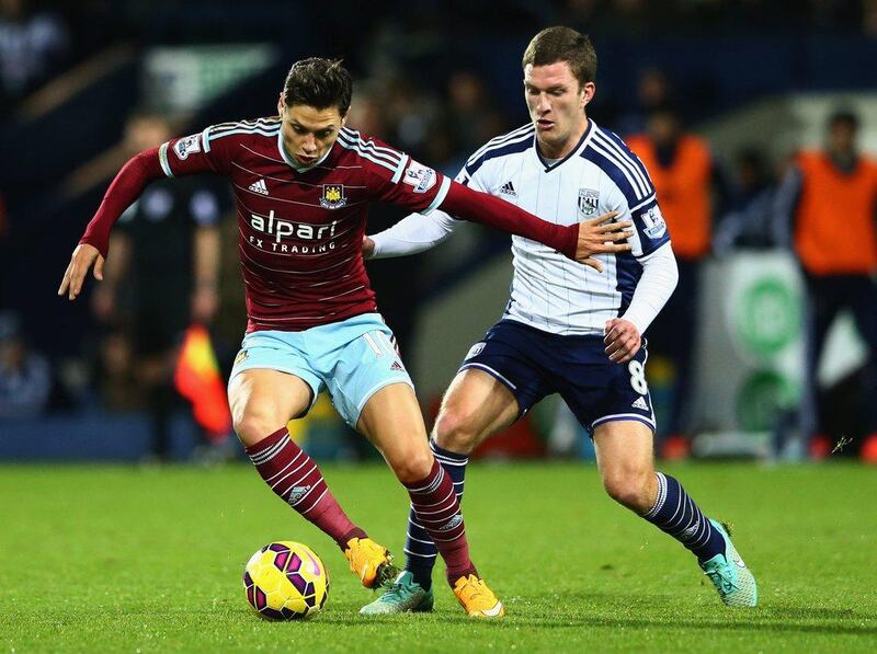 Mauro Zarate of West Ham United holds off Craig Gardner of West Bromwich Albion during their Premier League match on Tuesday. Matthew Lewis / Getty Images / December 2, 2014  