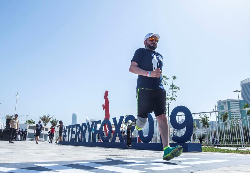 ABU DHABI, UNITED ARAB EMIRATES - Tareq who lost his legs during an accident finishing the run at the Terry Fox Run, Corniche Beach.  Leslie Pableo for The National