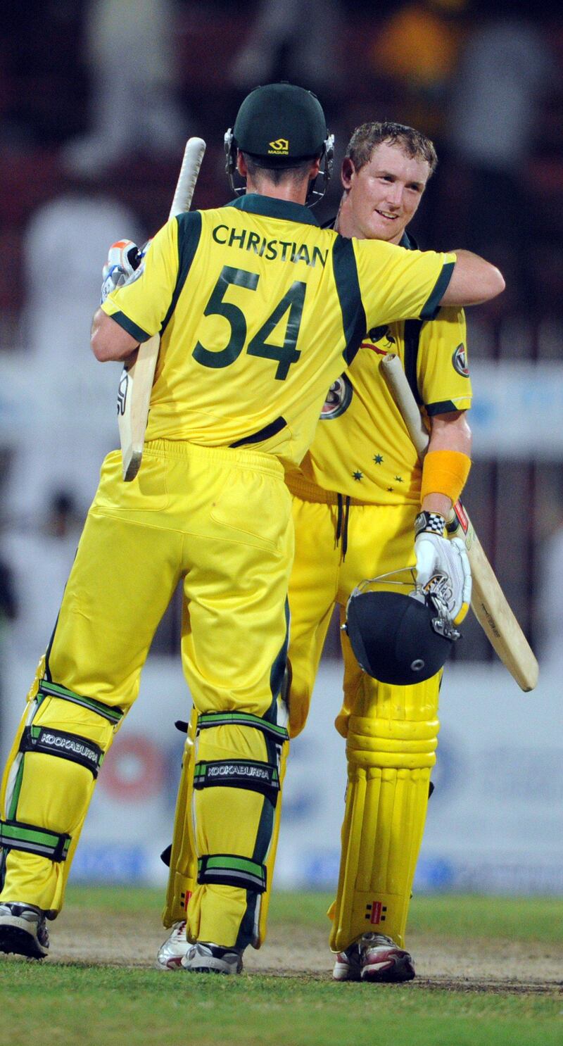 Australian cricketer George Bailey (R) hugs with his teammate Glenn Maxwell after winning the match against Pakistan on the first One Day International cricket match between Pakistan and Australia at the Sharjah cricket stadium on August 29, 2012. Australia beat Pakistan by four wickets in a hard-fought finish to the first limited overs international on August 29, taking a 1-0 lead in three-match series. AFP PHOTO / AAMIR QURESHI
 *** Local Caption ***  328693-01-08.jpg