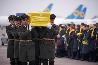 Soldiers carry a coffin containing the remains of one of the eleven Ukrainian victims of the Ukraine International Airlines flight 752 plane disaster. Reuters