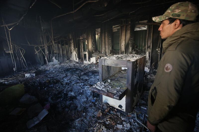 A man inspects the burnt entrance of the US embassy. AFP