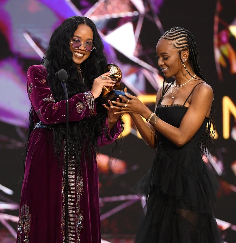 HER, left, and Tiara Thomas accept the Song of the Year award for 'I Can't Breathe' onstage during the 63rd Grammy Awards. AFP