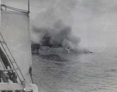 Seen from the deck of a salvage tug, the burnt out Dara sinks under tow to Dubai in April 1961. At least 240 people are believed to have died when a terrorist bomb caused a disastrous fire during a storm. UK National Archives