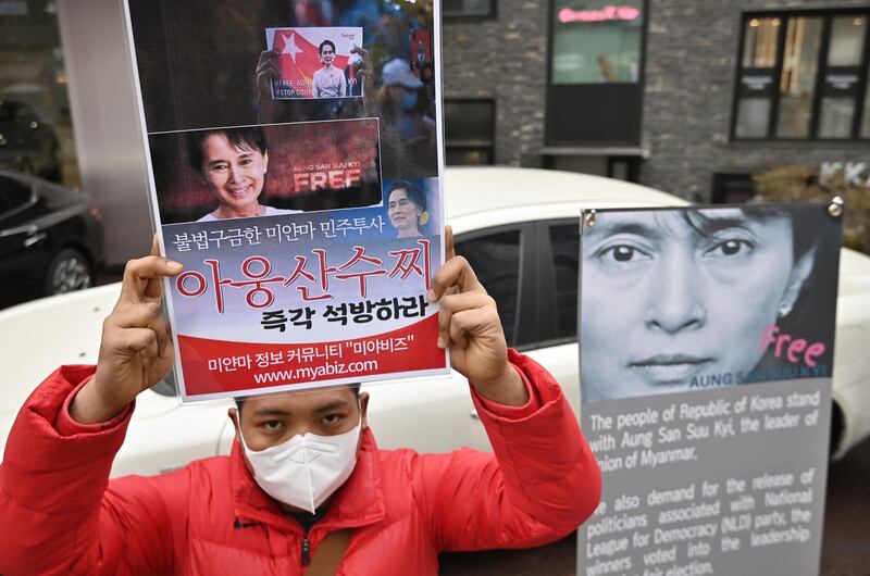 A protester holds a placard showing a picture of Aung San Suu Kyi during a demonstration near the military office of the Myanmar embassy in Seoul, South Korea to protests against the military coup in Myanmar on February 1, 2021. AFP