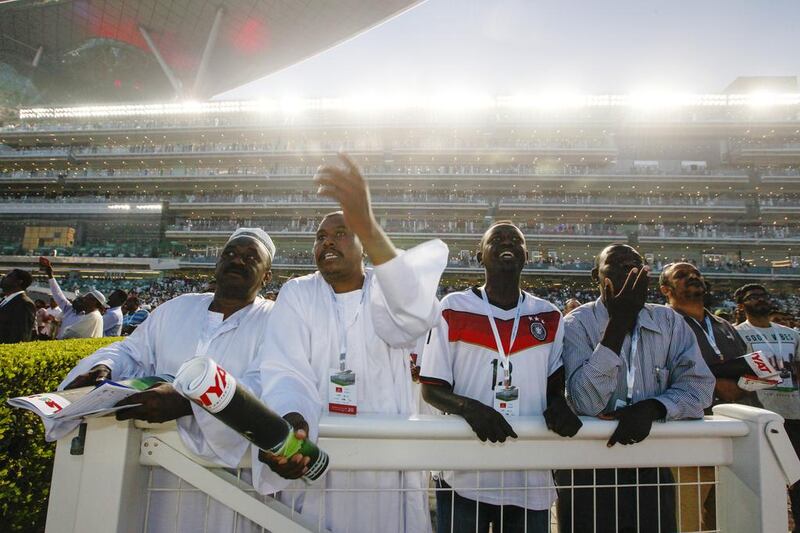 Racegoers cheer during Dubai World Cup at Meydan Racecourse in Dubai, March 28, 2015. (Photo by: Sarah Dea/The National)