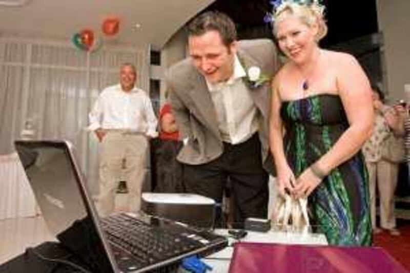 Dubai - April 17, 2010 - Sean Murtagh with his wife Natalie talk with relatives in London via an internet computer connection after they renewed their wedding vows in the Millennium Airport Hotel in Dubai April 17, 2010. The couple was married in Australia three weeks ago and were on their way back to London for their reception when their flight was delayed and they are laidover in Dubai due to the eruption of the Eyjafjallajökull volcano in Iceland.  (Photo by Jeff Topping/The National) 
 