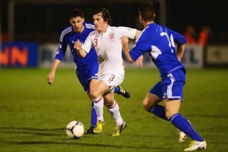 Leighton Baines, centre, of England takes on the San Marino defence during a World Cup qualifier on Friday in Serravalle, San Marino. England rolled to a 8-0 win. Mike Hewitt / Getty Images