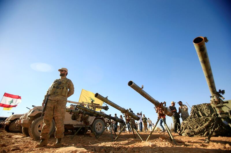A Hezbollah fighter stands in front of anti-tank artillery at Juroud Arsal, the Syria-Lebanon border. Ali Hashisho.