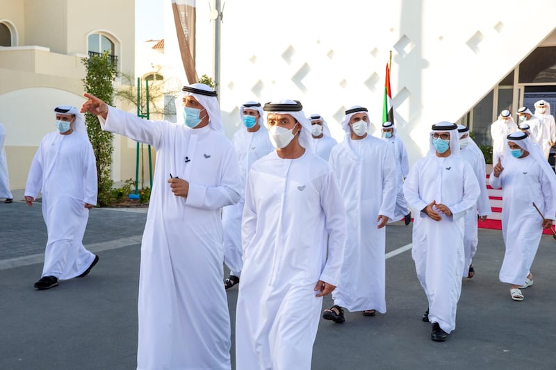 AL SAMHA, ABU DHABI, UNITED ARAB EMIRATES - October 21, 2020: HH Sheikh Hazza bin Zayed Al Nahyan, Vice Chairman of the Abu Dhabi Executive Council (R)  tours Emirati Housing Neighborhood, in Al Samha City. Seen with HE Dr Mugheer Al Khaili, Chairman of the Department of Community Development and Abu Dhabi Executive Council Member (back 2nd R) and HH Major General Sheikh Khaled bin Mohamed bin Zayed Al Nahyan, Deputy National Security Adviser, member of the Abu Dhabi Executive Council and Chairman of Abu Dhabi Executive Office (Back 3rd R).

( Mohamed Al Baloushi for the Ministry of Presidential Affairs )
---