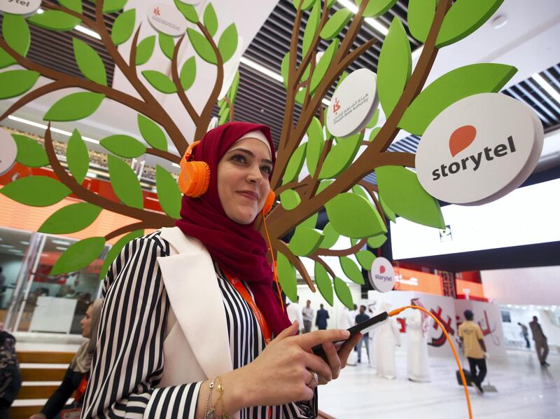 SHARJAH, UNITED ARAB EMIRATES - An audio book by storytel company being enjoyed by a guest to The Sharjah Book Fair.  Leslie Pableo for The National