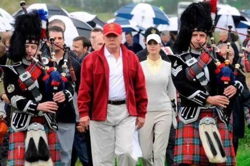 Donald Trump is escorted by Scottish pipers as he opens Trump International Golf Links.