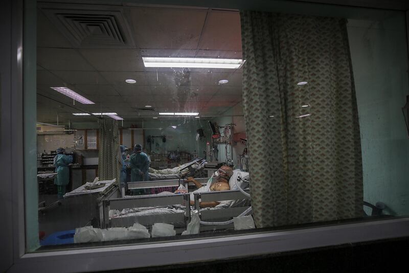 Members of the clinical staff wearing Personal Protective Equipment (PPE) care for a patient with coronavirus in the intensive care unit at the European Hospital, east of Rafah town, southern Gaza strip. The European Hospital, which has been classified as the Epidemiology Hospital since the start of the coronavirus in the Gaza Strip on 25 August 2020, has 334 infected cases under clinical care including 109 severe and critical cases. The production capacity of oxygen is 2,200 liters per minute, and there has become a large deficit after the increasing number of infections with Coronavirus.  EPA