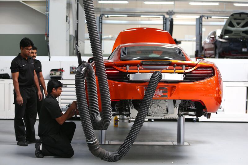 DUBAI , UNITED ARAB EMIRATES : July 3 , 2013 -  McLaren technicians working on the MP4 12C McLaren car at the Al Habtoor Motors workshop in Dubai Industrial City in Dubai. ( Pawan Singh / The National ) . For Business