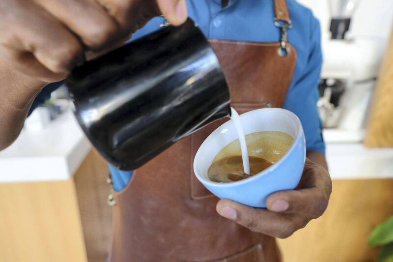 Abu Dhabi, United Arab Emirates - March 11, 2019: Vusi Nkomo, Head barista makes a coffee. Feature story on the Rain Cafe, Abu Dhabi. Monday the 11th of March 2019 on Abu Dhabi. Chris Whiteoak / The National