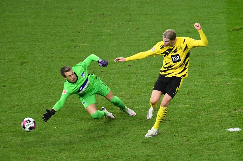 Dortmund's Erling Braut Haaland finishes past Hertha Berlin goalkeeper Alexander Schwolow to complete his hat-trick. AFP