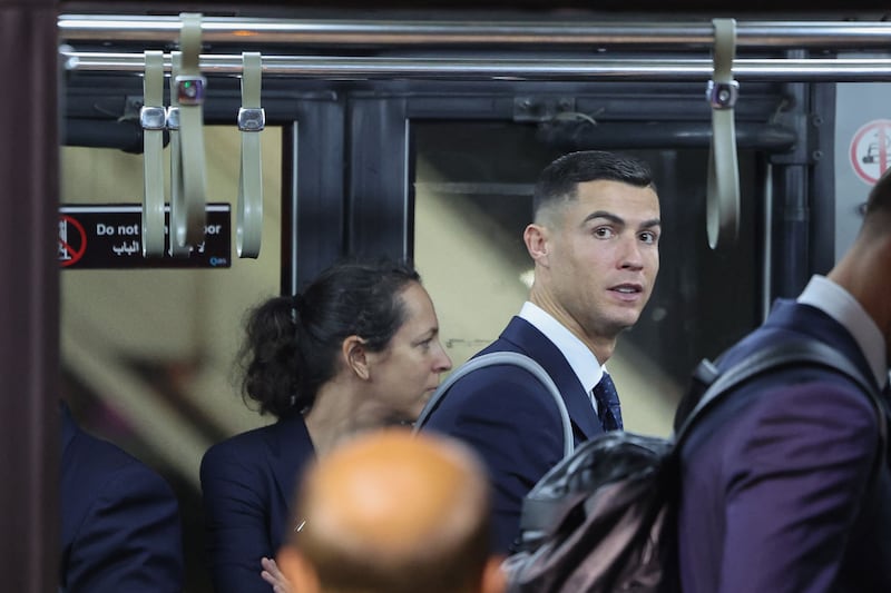 Portugal forward Cristiano Ronaldo (C) board a bus after arriving at the Hamad International Airport in Doha on Friday night, November 18, 2022, ahead of the Qatar World Cup. AFP