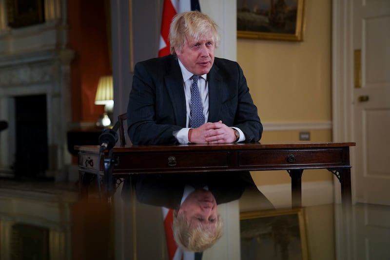 Boris Johnson urged people to have a booster vaccine as he gave a warning of a 'tidal wave' of infections caused by the Omicron variant when he addressed the nation on Sunday evening. AP Photo