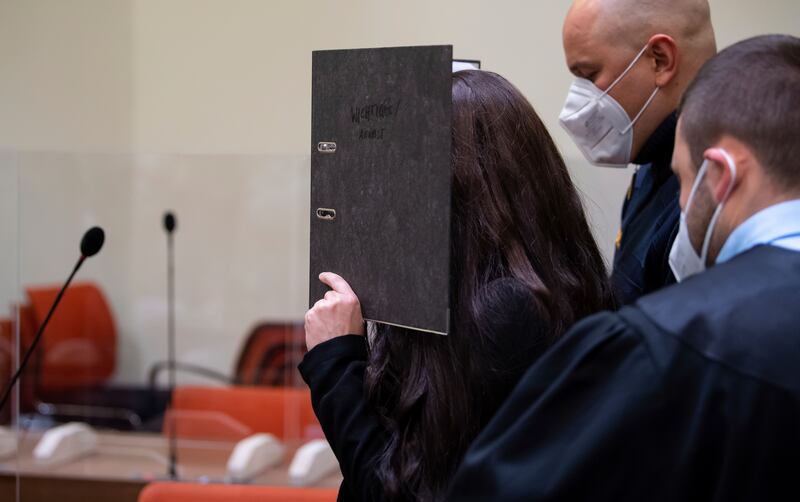 Jennifer Wenisch hides her face as she arrives in court in Munich, Germany. AP