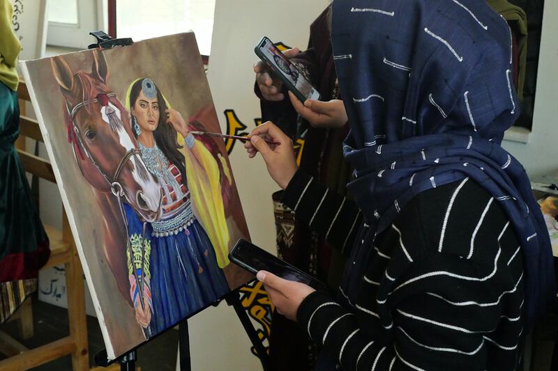 Pictured: Artist work together on a painting at ArtLords headquarters in Kabul. 
Photo by Charlie Faulkner
February 2021