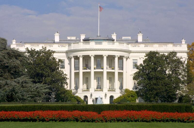 381943 04: FILE PHOTO: A flag flies atop the White House November 15, 2000 in Washington, DC. It has been reported February 7, 2001 that a man, identified as a 17 year old and later described as a white male in his forties, was shot in the leg outside the White House grounds by security personnel. The subject who was reportedly carrying a gun, was a possible suicide attempt, as well as, a threat to the well being of White House personnel. (Photo by Alex Wong/Newsmakers)