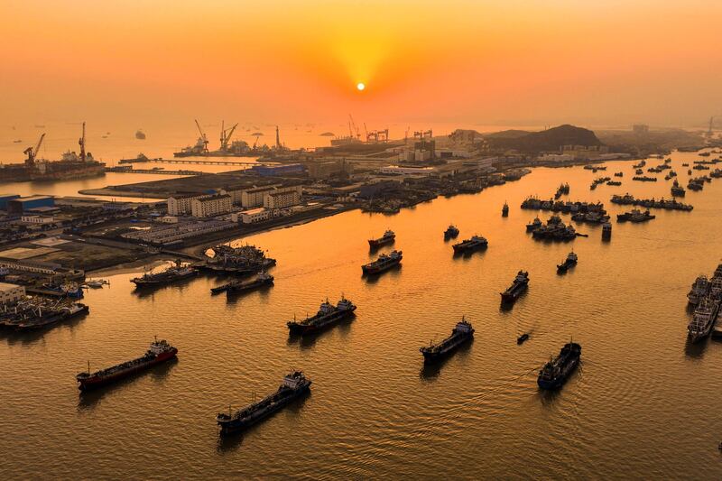 Boats sail past Shenjiamen Fishing Port during sunset in Zhoushan, eastern China. AFP