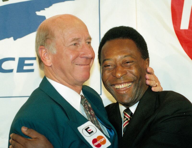 Sir Bobby Charlton of England, left, and Pele, of Brazil, embrace at an event in 1995. AP