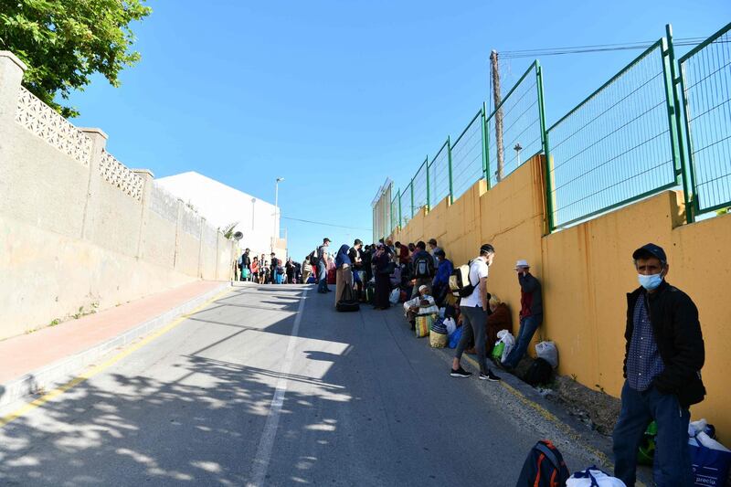 Moroccan citizens stranded in Spain due to coronavirus crisis, queue to take the coach that will repatriate them in the Spanish enclave of Ceuta.  AFP