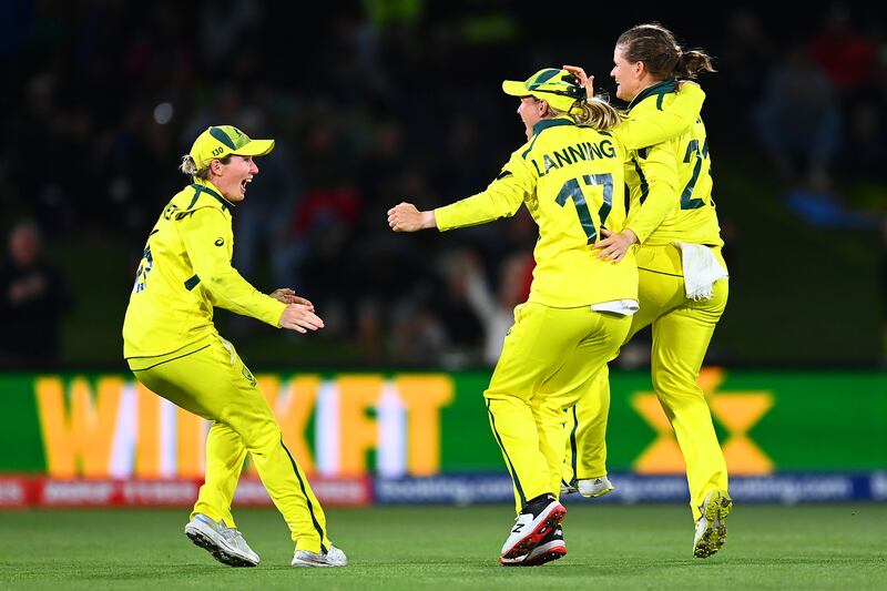 Australia players Beth Mooney, Jess Jonassen and Meg Lanning celebrate winning the 2022 Women's Cricket World Cup. Getty