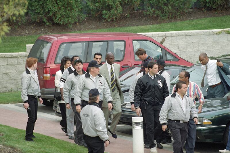 Jordan is surrounded by Comiskey Park security as he arrives at the Berto Centre in Deerfield, Illinois to announce his retirement from professional basketball in 1993. AP