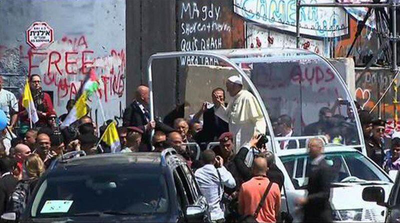 A video grab taken from Palestinian TV shows Pope Francis waving to the crowd from inside the popemobile as he makes an unscheduled stop in front of the West Bank’s separation barrier on May 25, 2014 in the town of Bethlehem. Palestinian TV/AFP Photo