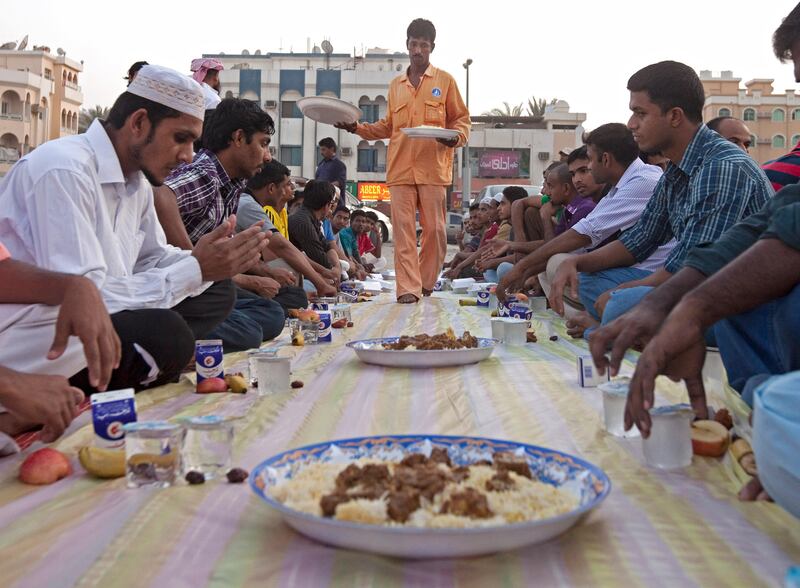 Ajman, August 7, 2011 - Al Ihsan Charity Center volunteer Kawsaor Miah sets a plate of biryani for those attending Iftar at the Ahmed Mohammad Saeed Mosque in Ajman City, August 7, 2011. (Jeff Topping/The National) 