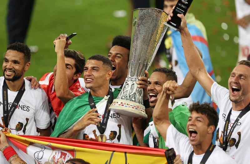 Soccer Football - Europa League - Final - Sevilla v Inter Milan - RheinEnergieStadion, Cologne, Germany - August 21, 2020  Sevilla's Diego Carlos and Fernando celebrate with the trophy after winning the UEFA Europa League, as play resumes behind closed doors following the outbreak of the coronavirus disease (COVID-19)   Lars Baron/Pool via REUTERS