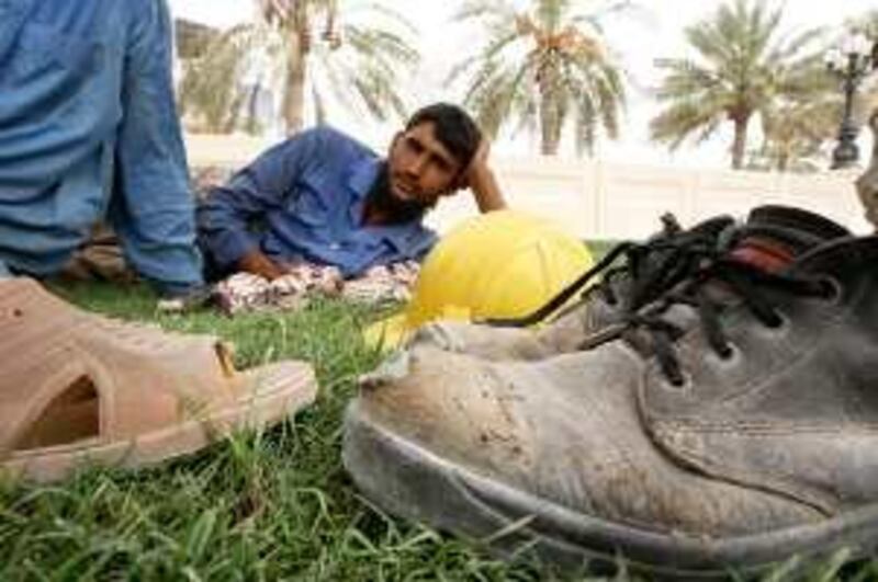 
SHARJAH, UNITED ARAB EMIRATES Ð July 6: Construction workers taking rest under the tree during the midday break at Sharjah corniche, but they have makeshift shelter to rest during the break at the construction site in Sharjah. (Pawan Singh / The National) For News
 *** Local Caption ***  PS02- MIDDAY BREAK.jpg