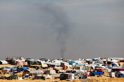 Smoke from Israeli strikes rises behind a camp for displaced Gazans in Rafah. Reuters