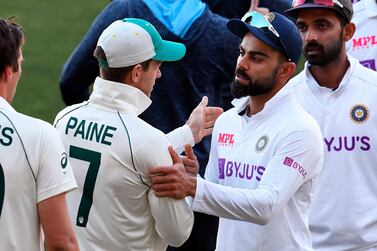 TOPSHOT - India's captain Virat Kohli (2/R) congratulates Australia's captain Tim Paine (2/L) on the third day of the first cricket Test match between Australia and India played in Adelaide on December 19, 2020. -- IMAGE RESTRICTED TO EDITORIAL USE - STRICTLY NO COMMERCIAL USE -- / AFP / William WEST / -- IMAGE RESTRICTED TO EDITORIAL USE - STRICTLY NO COMMERCIAL USE --