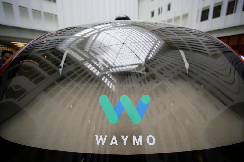 FILE- In this Dec. 13, 2016, file photo a skylight is reflected in the rear window of a Waymo driverless car during a Google event in San Francisco. Just days after ride-hailing service Uber announced it was testing tractor-trailers that drive themselves, Googleâ€™s autonomous vehicle operation announced similar testing in Georgia on Friday, March 9, 2018. Waymo says that starting next week it will run self-driving rigs in the Atlanta area with human backup drivers. (AP Photo/Eric Risberg, File)