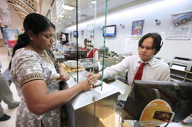 A woman sends money home via UAE Exchange in Al Barsha in Dubai. Female expatriates are more likely to remit a higher proportion of their salaries compared with men, according to new data by the Foreign Exchange and Remittance Group. Pawan Singh / The National