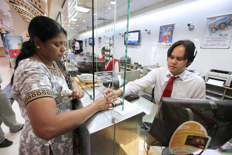 A woman sends money home via UAE Exchange in Al Barsha in Dubai. Female expatriates are more likely to remit a higher proportion of their salaries compared with men, according to new data by the Foreign Exchange and Remittance Group. Pawan Singh / The National