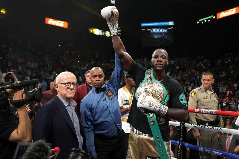 WBC heavyweight champion Deontay Wilder poses with referee Kenny Bayless after defeating Luis Ortiz. AFP