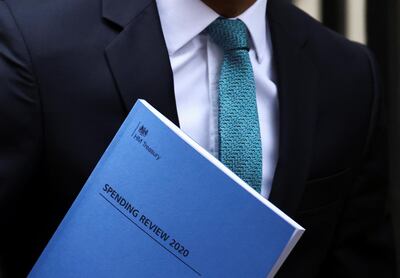 Britain's Chancellor of the Exchequer Rishi Sunak carries the "Spending Review 2020" document as he leaves Downing Street, in London, Britain, November 25, 2020. REUTERS/Henry Nicholls