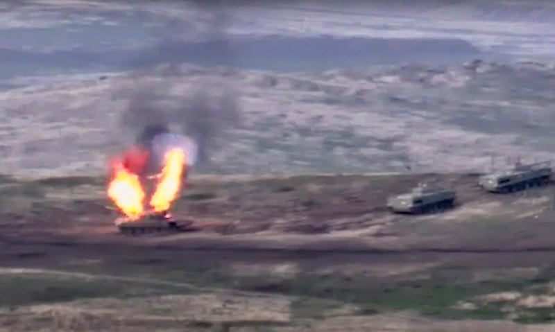 In this image taken from a footage released by Armenian Defense Ministry, Armenian forces destroy Azerbaijani tank at the contact line of the self-proclaimed Republic of Nagorno-Karabakh, Azerbaijan.  AP